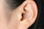 Close-up of human ear showing outer ear structure and ear canal